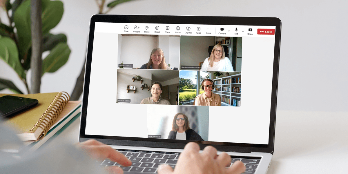 A laptop showing a video call with multiple participants