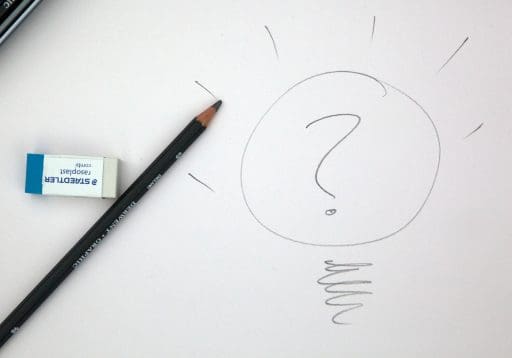 A hand drawn lightbulb with question mark inside . A pencil and Eraser are to the side