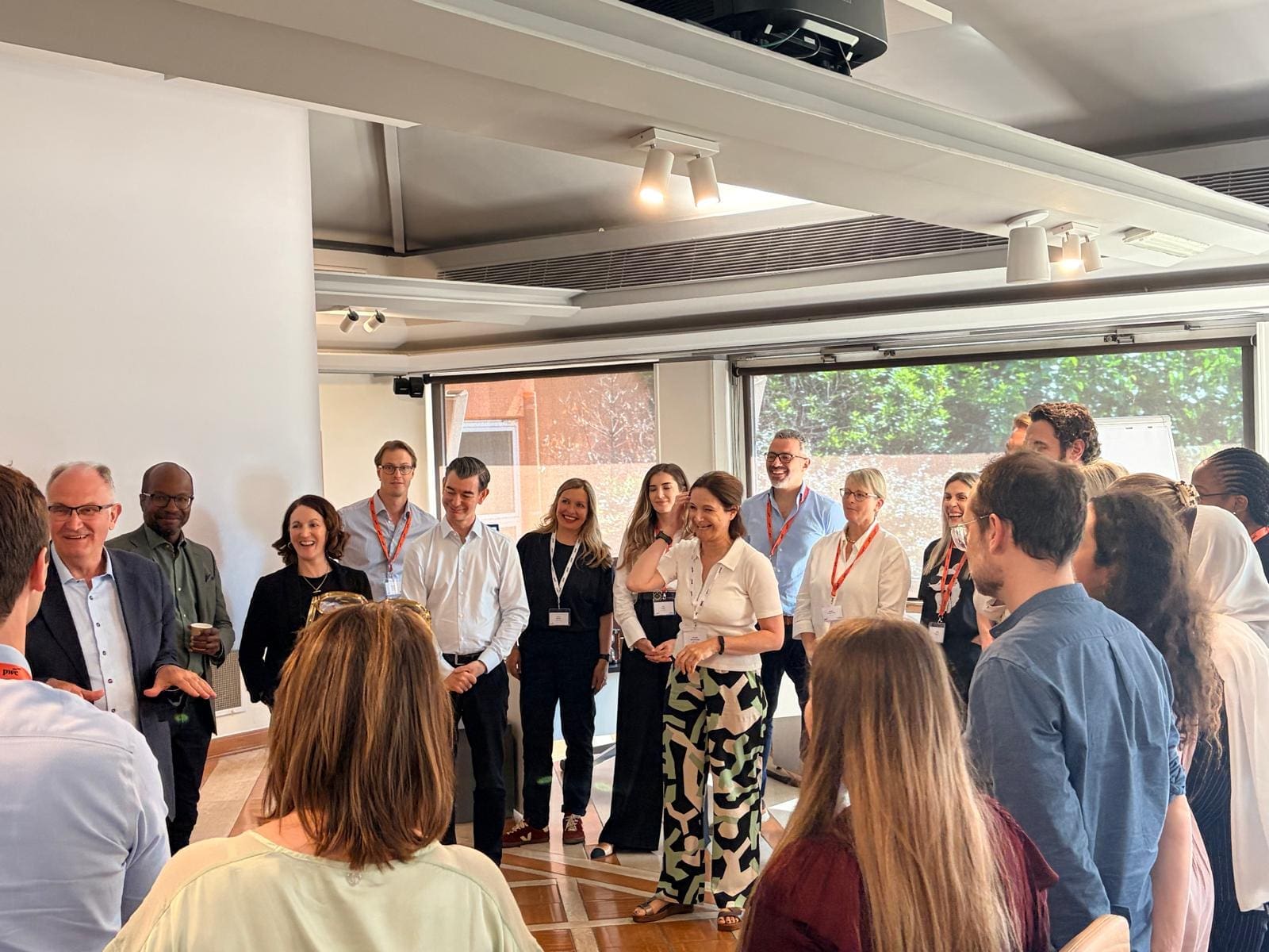 A room filled with professionals attending a learning and development programme with Nicki Kavanagh standing talking in the middle