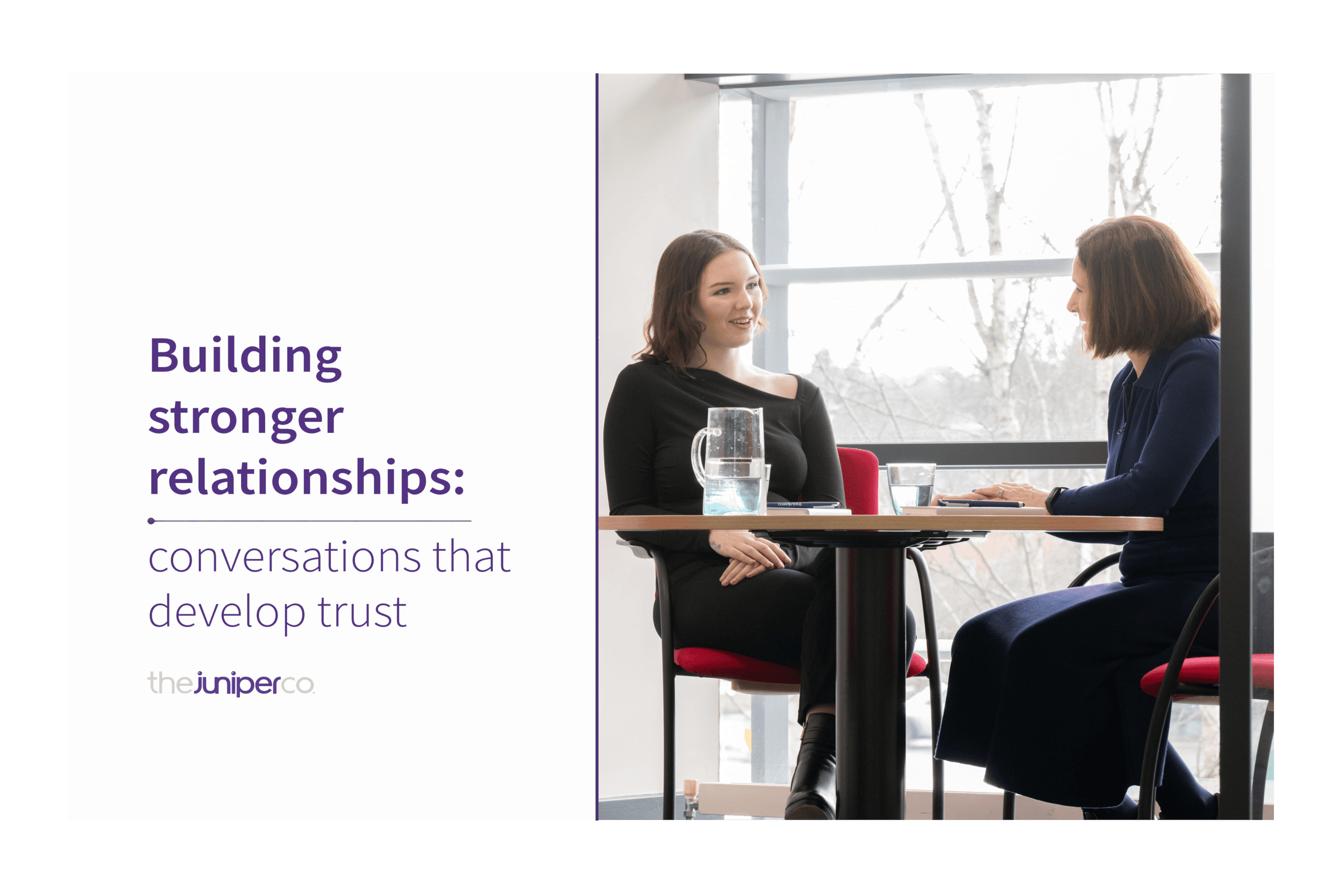 Two people are sitting at a table having a conversation